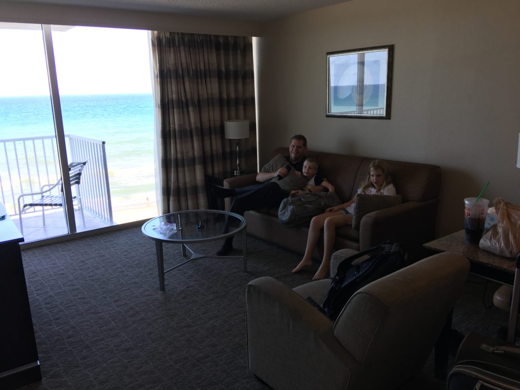 a man and two children sitting on a couch in a living room