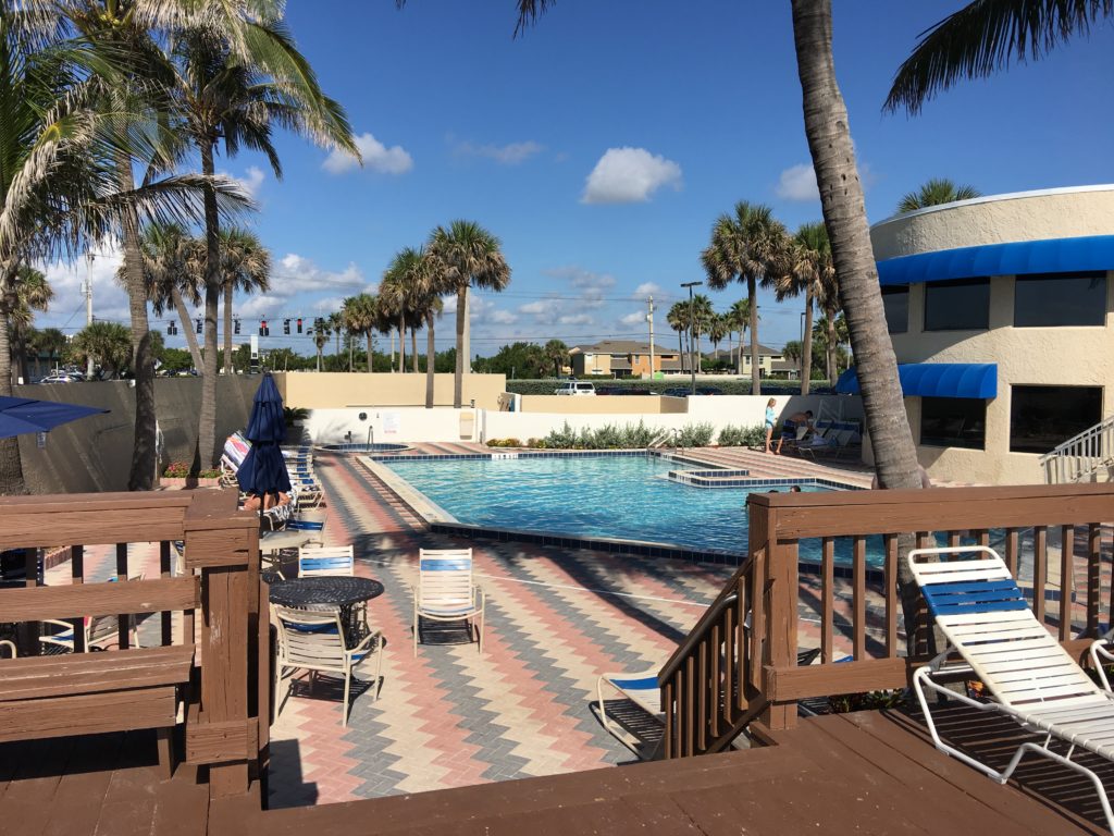 a pool with chairs and a deck