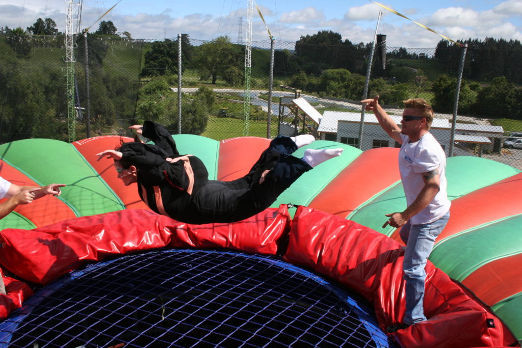 a man jumping on a trampoline