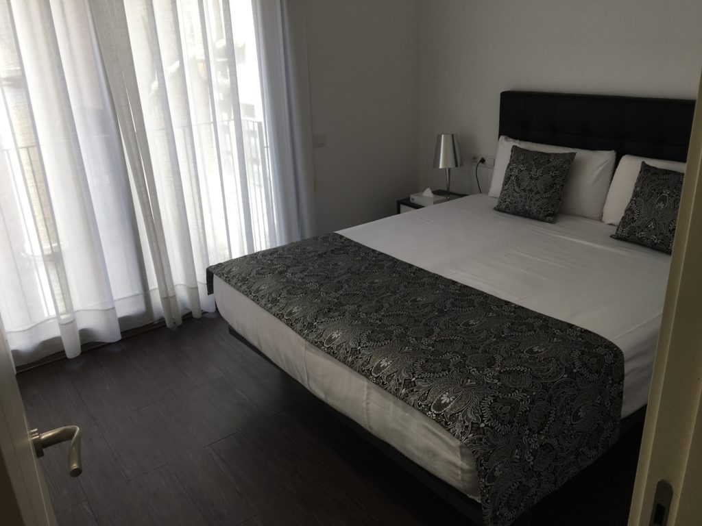 a bed with pillows and a lamp in a room