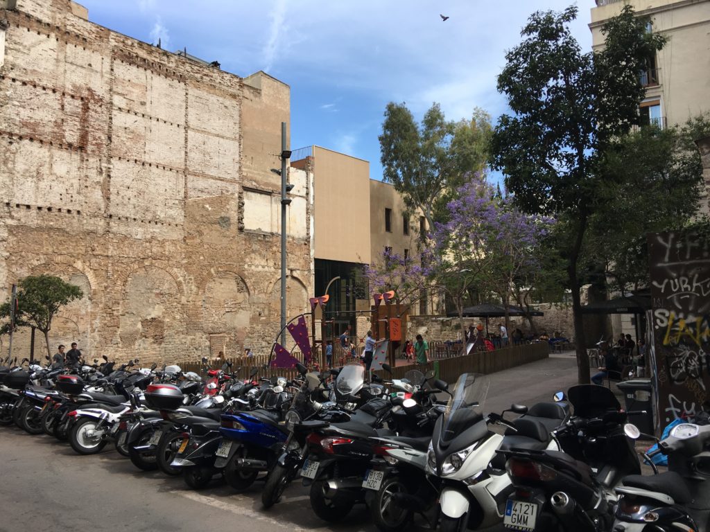 a group of motorcycles parked in a parking lot