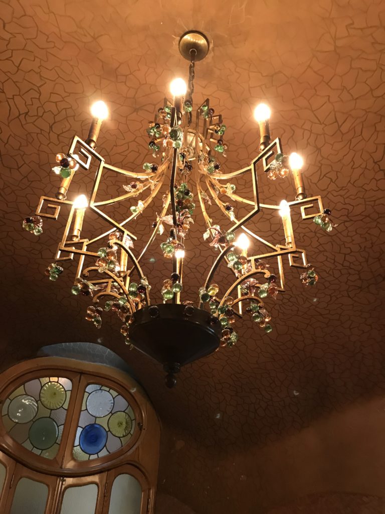a chandelier with lights from the ceiling