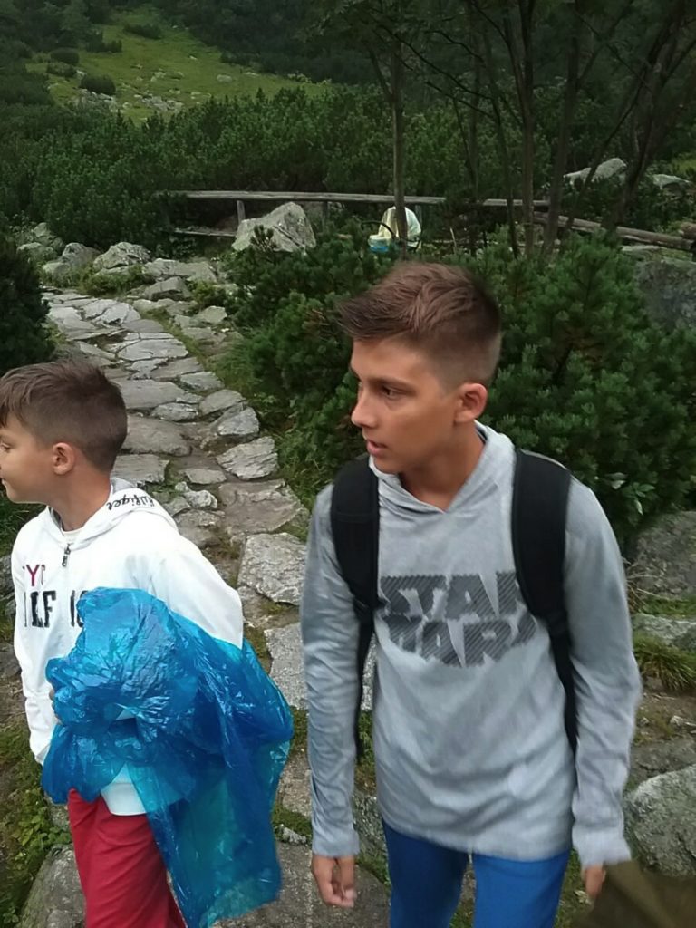 a group of boys walking on a path