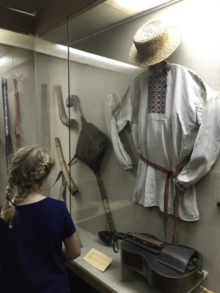 a woman looking at a person in a hat