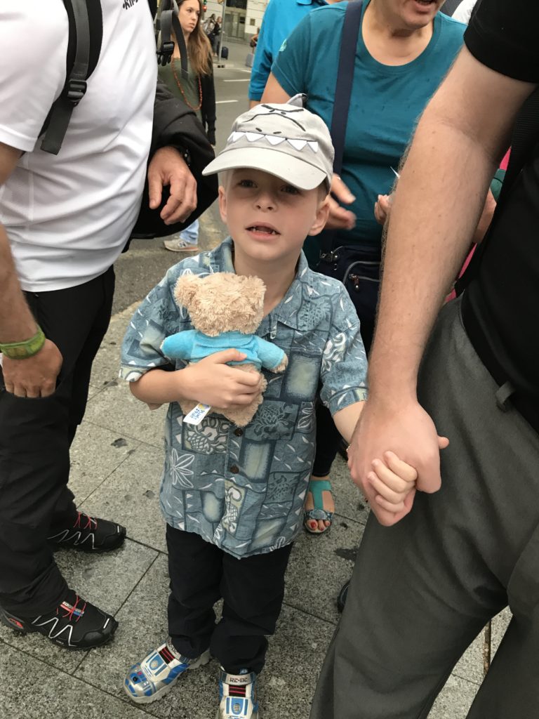 a boy holding a stuffed animal
