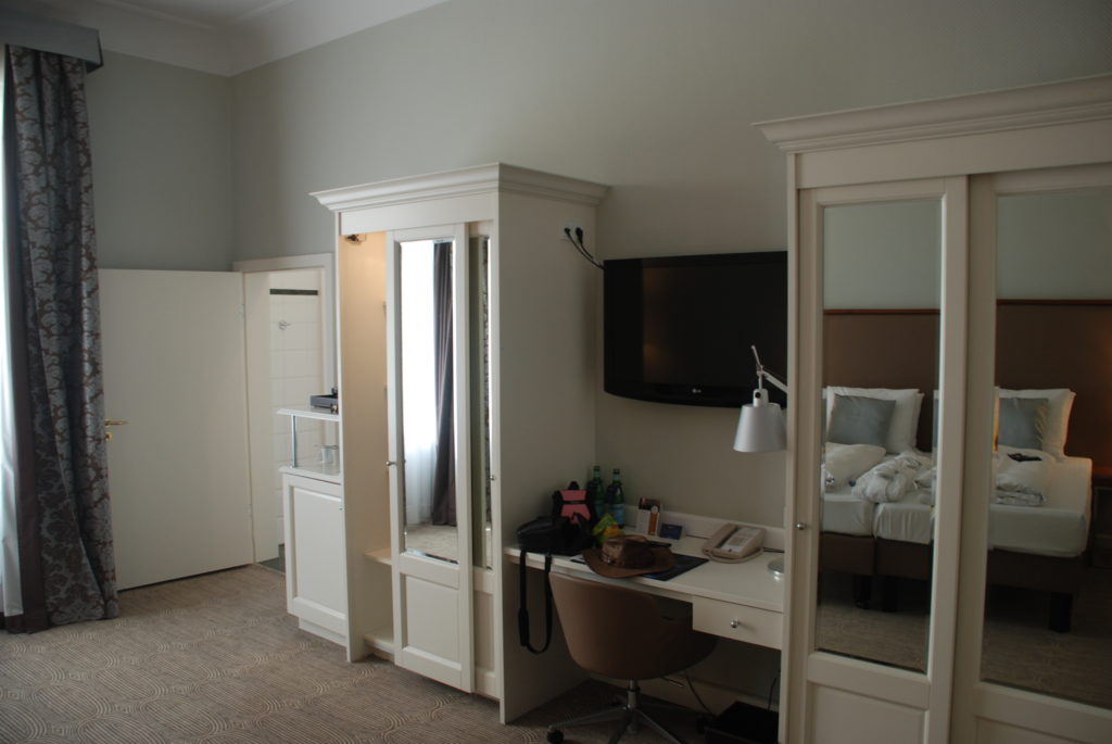 a room with a bed and a desk