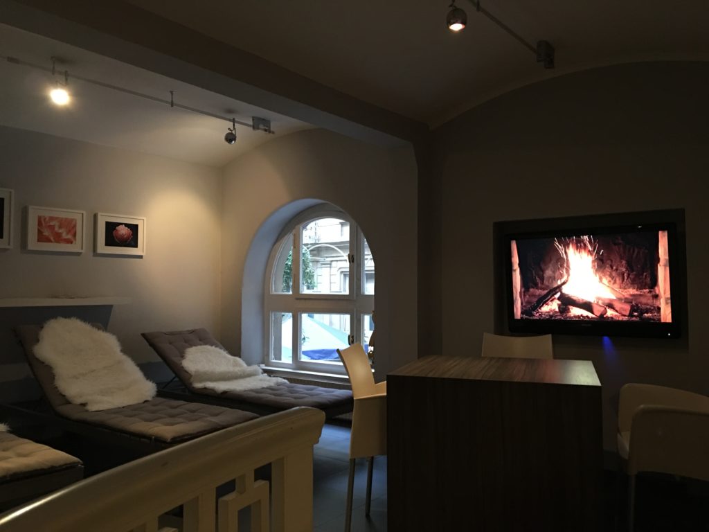 a room with a television and a fireplace
