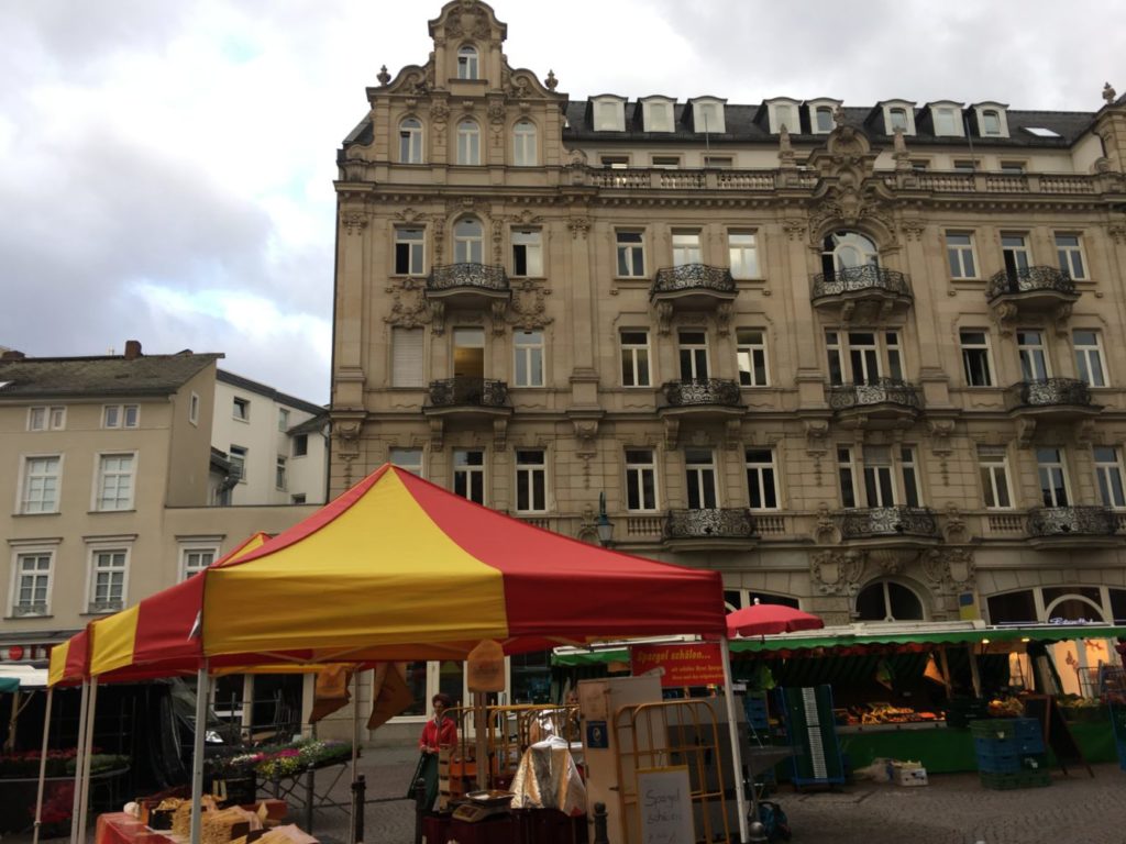 a large building with many windows and a tent in front of it