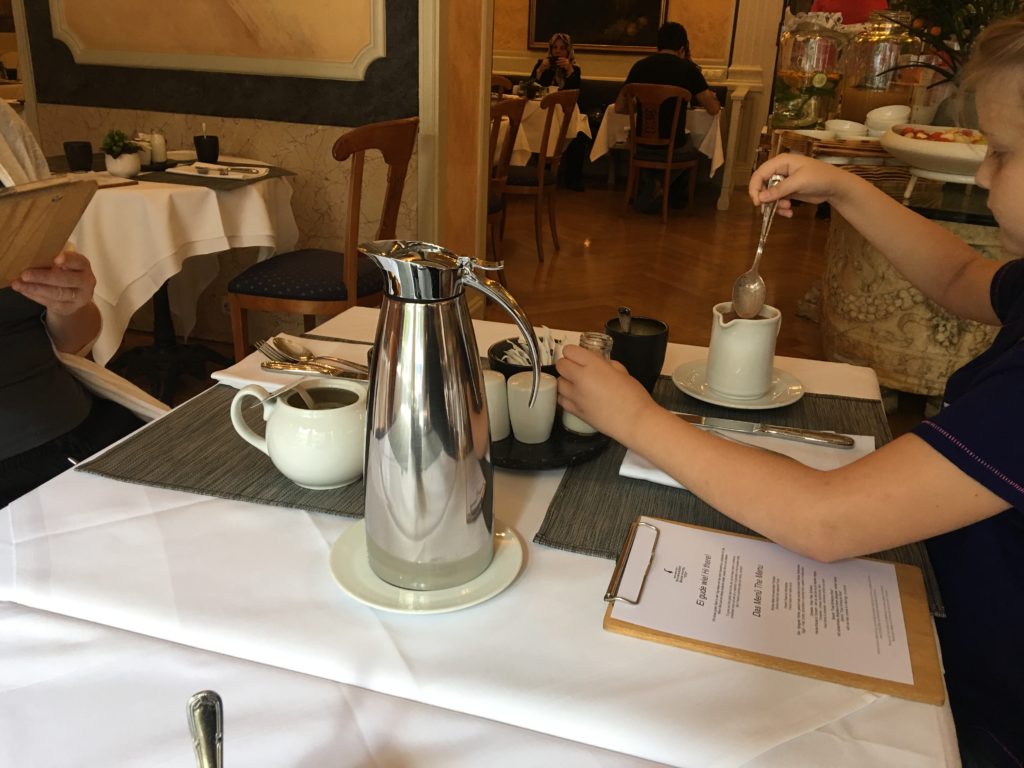 a person pouring a drink into a cup