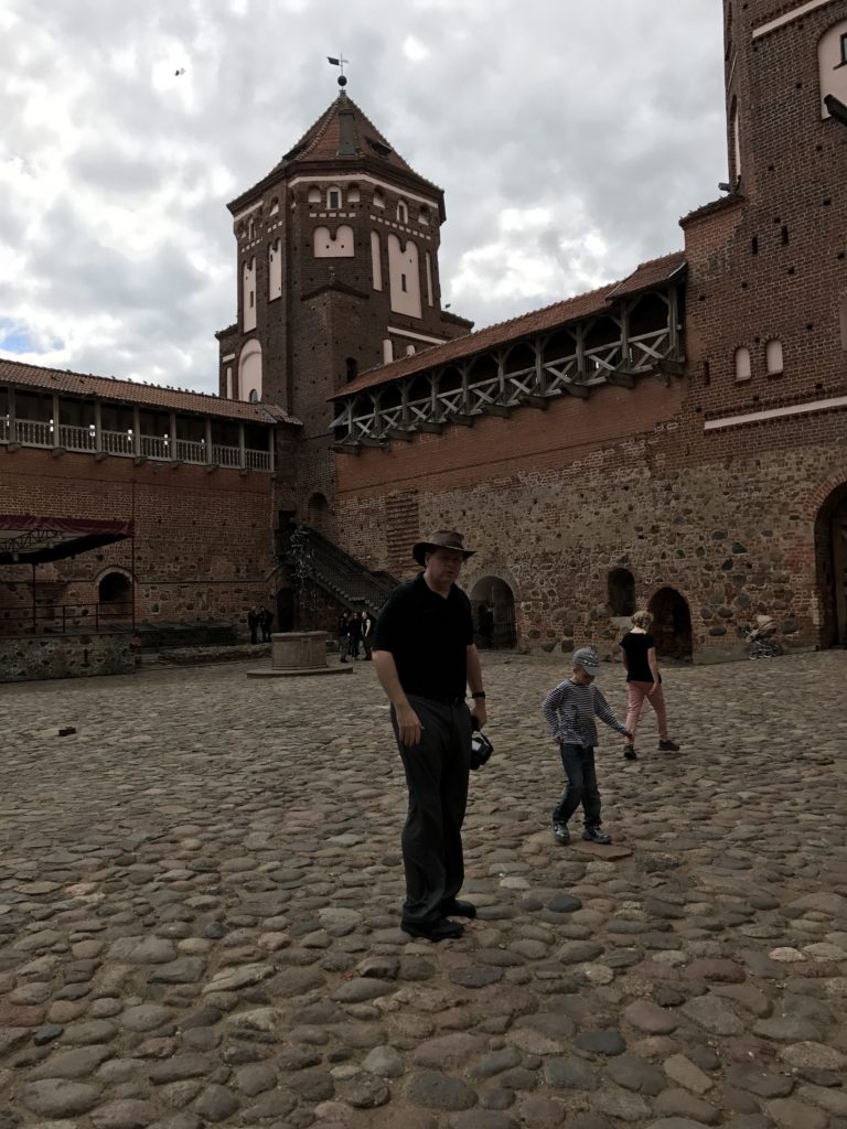 a man standing in front of a brick building