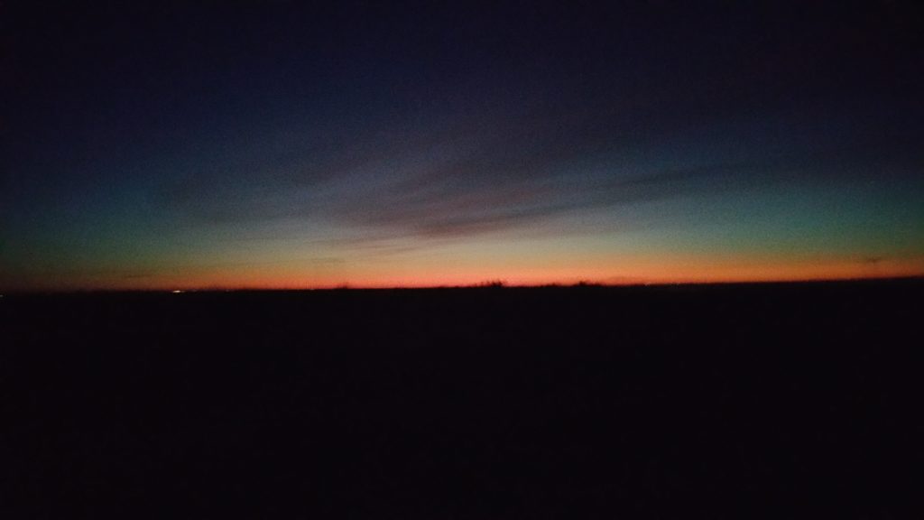 a sunset over a field