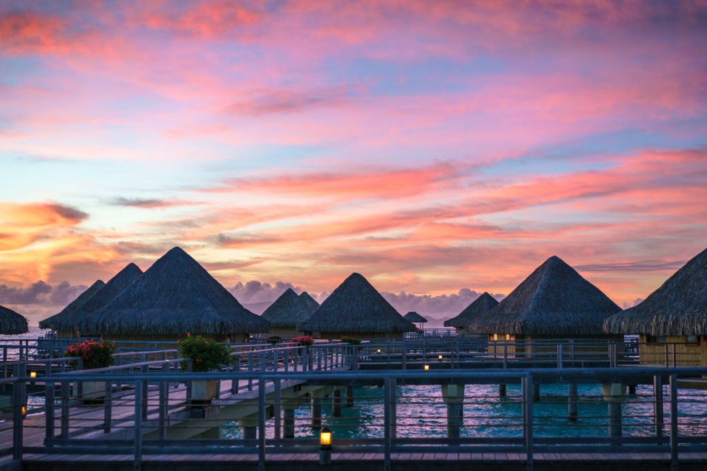 a group of huts on a pier
