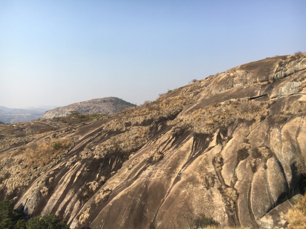 a rocky hill with grass on it