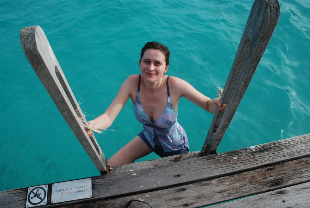 a woman in a swimsuit on a dock