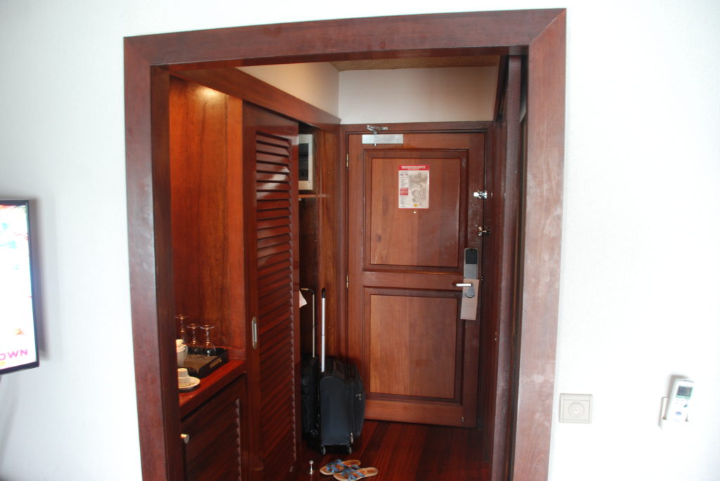 a room with a door and a suitcase