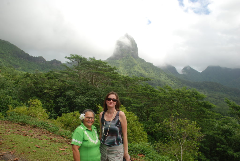 two women standing in front of a mountain