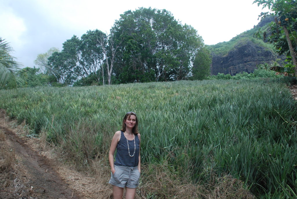 a woman standing in a field of tall grass