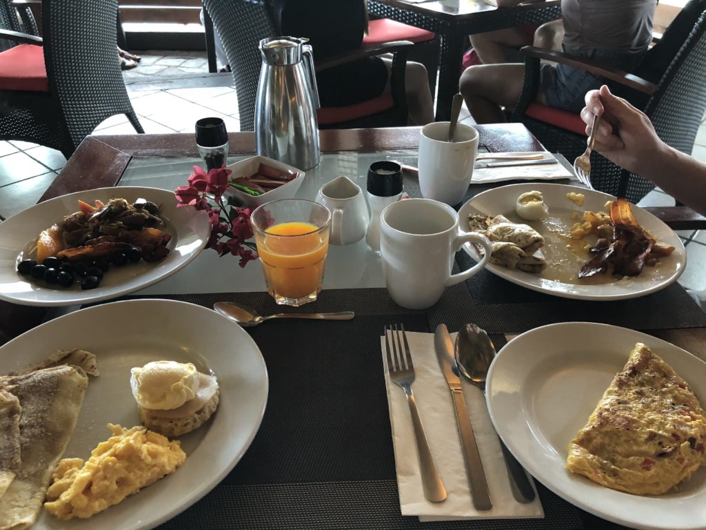 a table with plates of food and drinks
