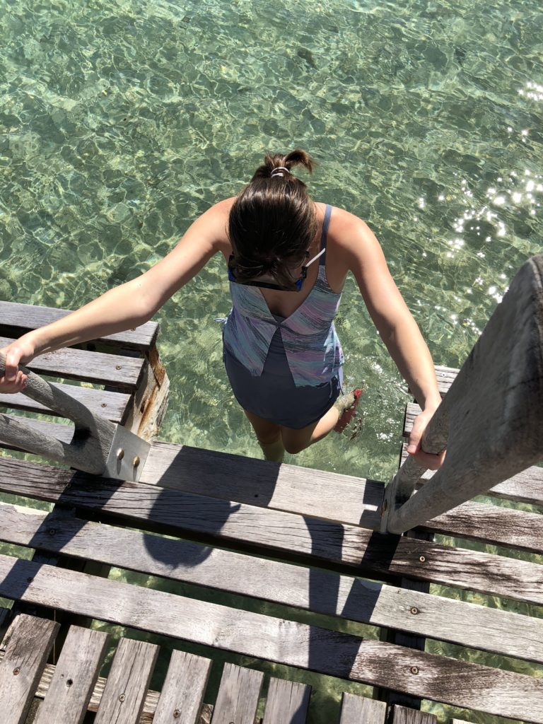 a woman walking into the water