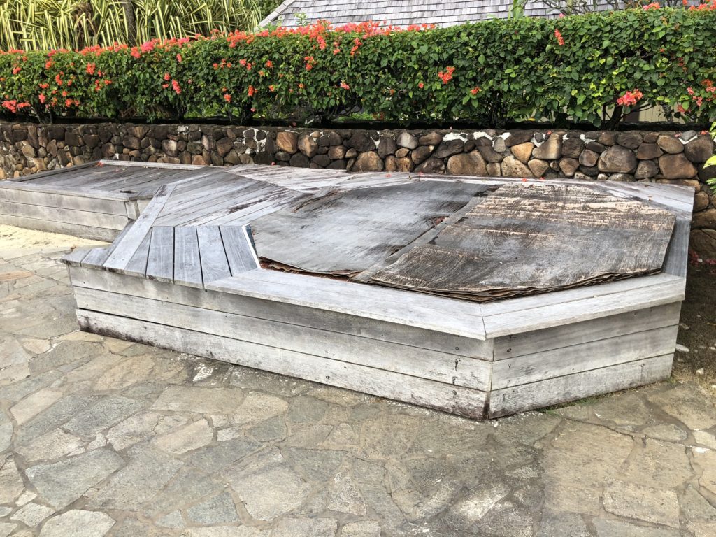 a wooden bench with a roof