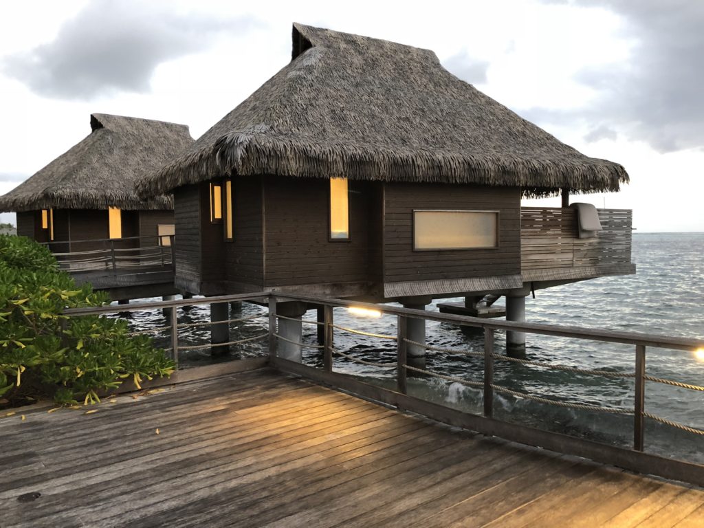 a two huts on stilts over water