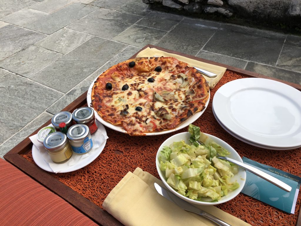 a pizza and salad on a table