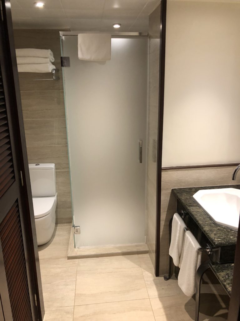 a bathroom with a glass shower door