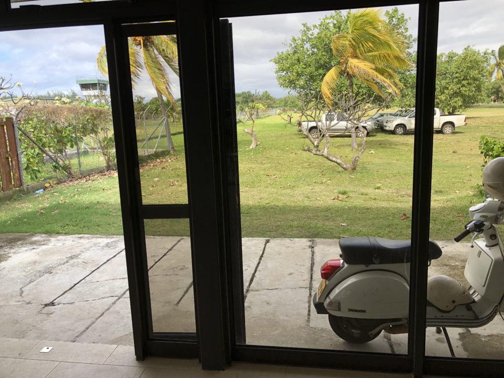 a moped parked outside a glass door