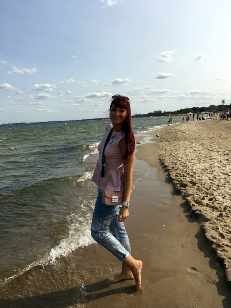 a woman standing on a beach