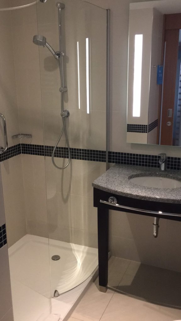 a bathroom with a shower and sink