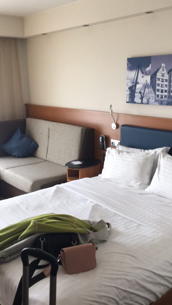 a bed with a backpack on it