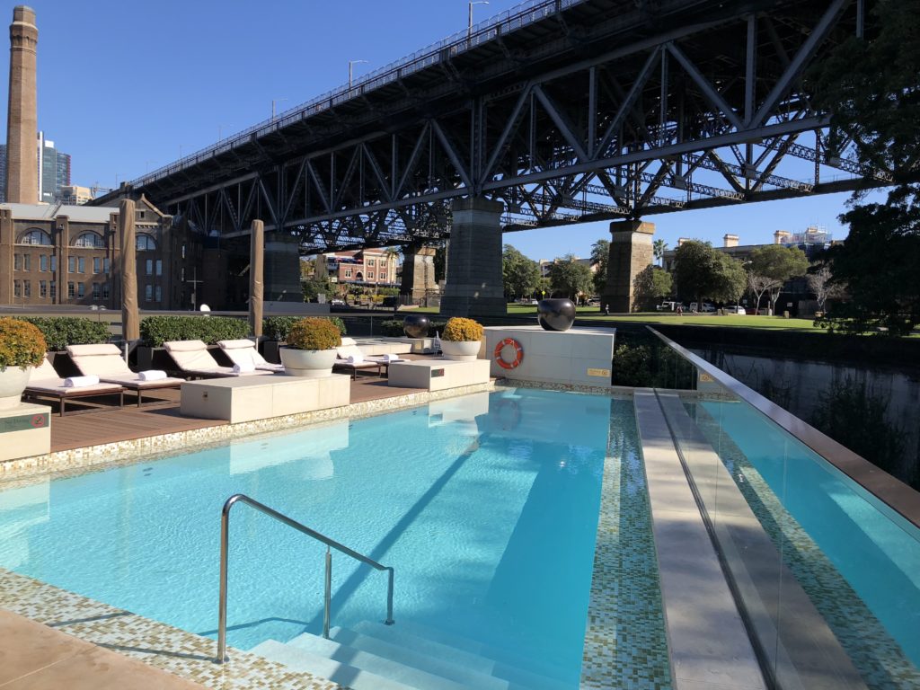 a swimming pool under a bridge