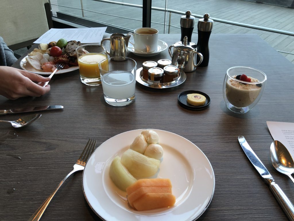 a plate of fruit and a glass of juice on a table