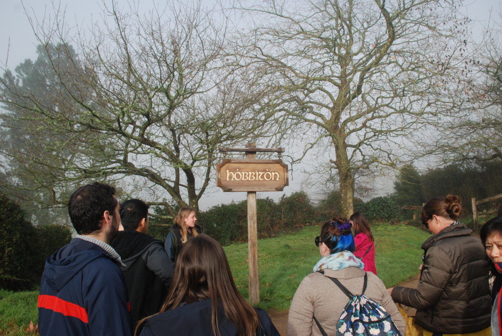 a group of people standing in front of a sign