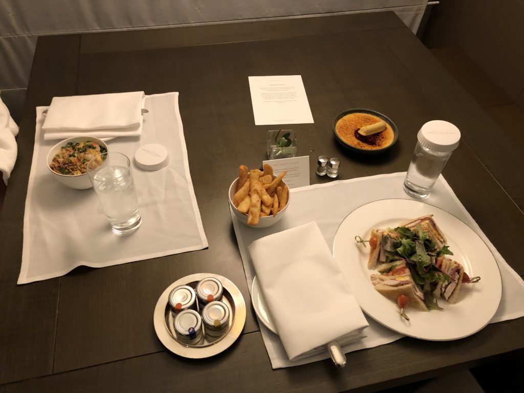 a table with plates of food and drinks