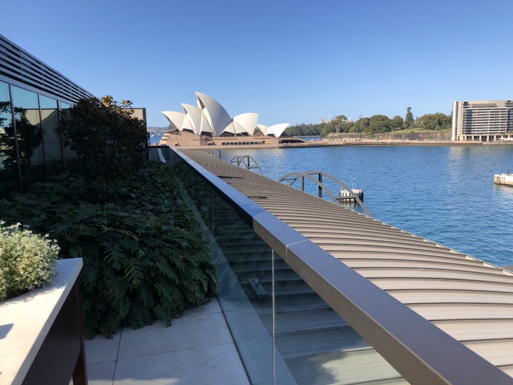 a bridge over water with a building in the background