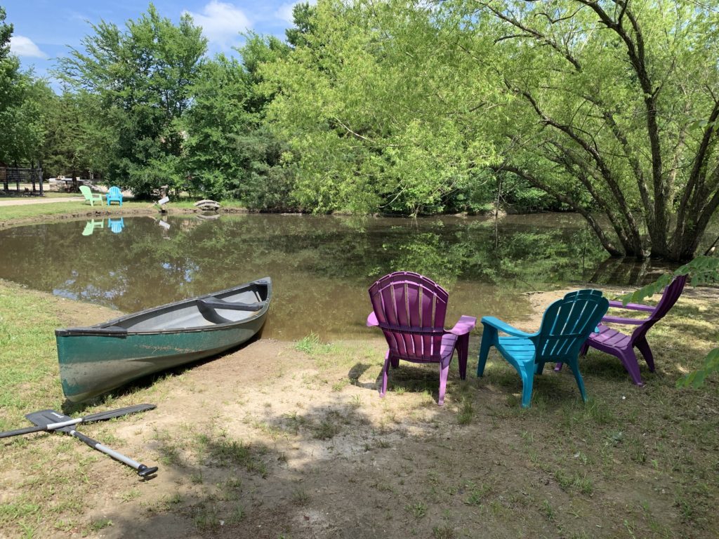 a row of chairs next to a canoe
