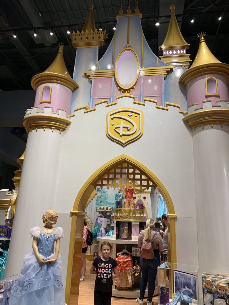 a girl standing in front of a castle