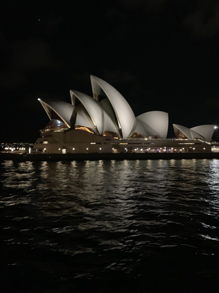 Sydney Opera House with pointed roofs on water