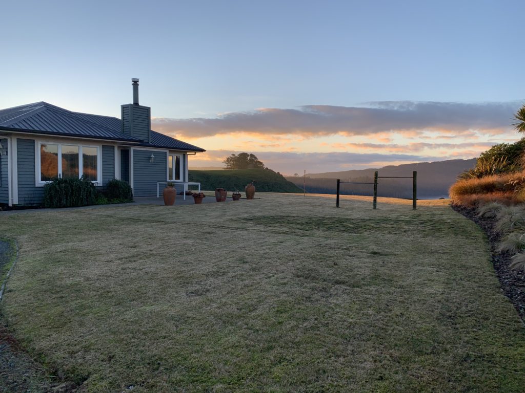 a house with a lawn and a fence