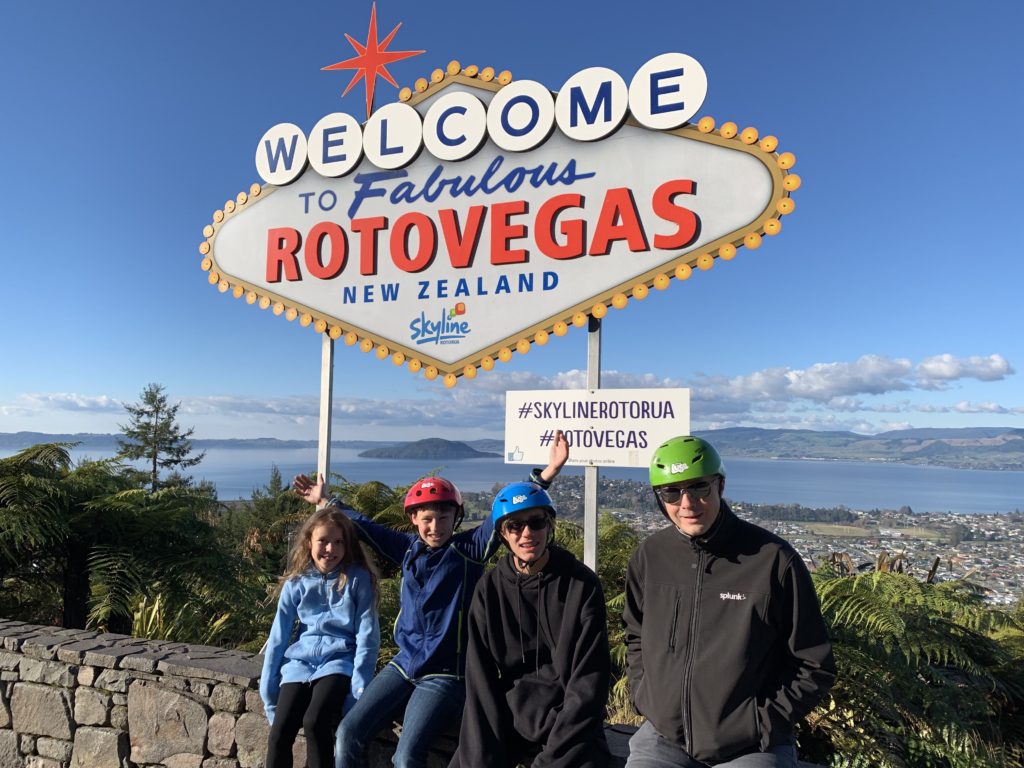 a group of people posing for a picture in front of a sign