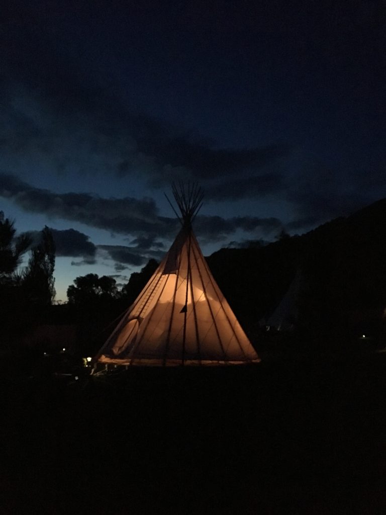 a lit teepee at night