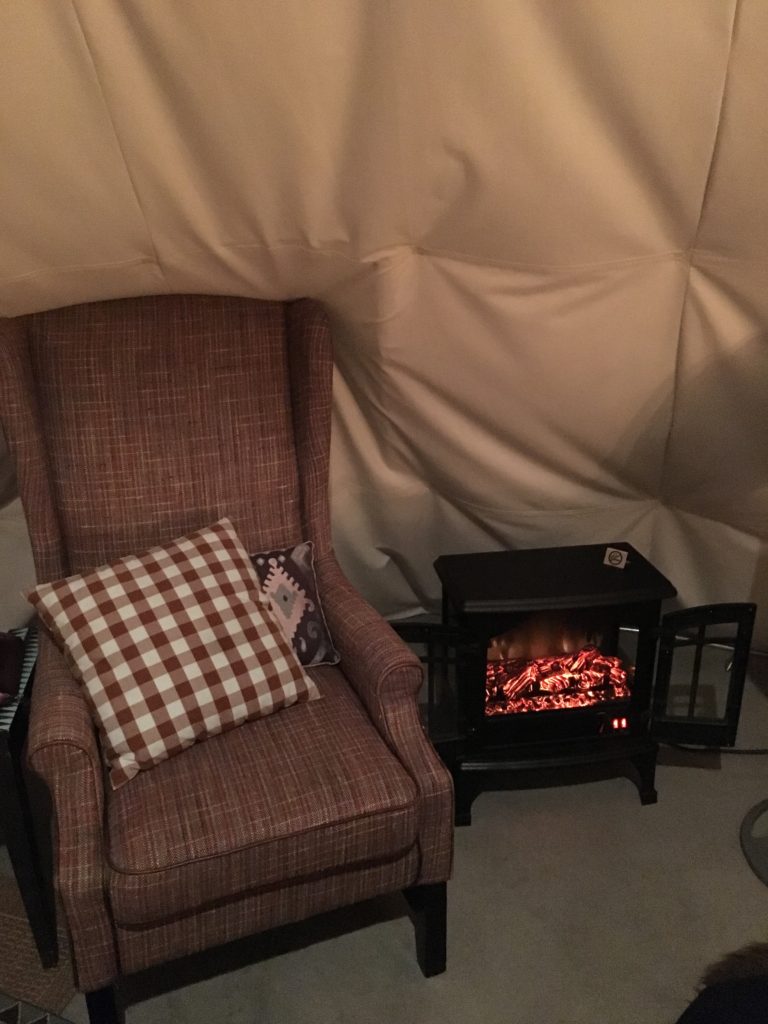 a chair and a small fireplace