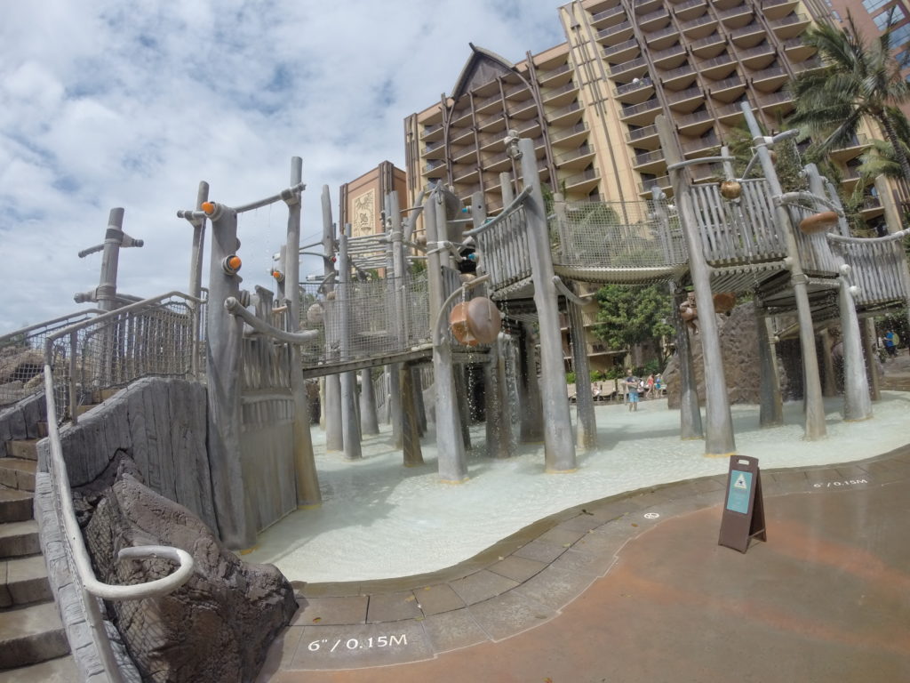 a playground with a large building in the background