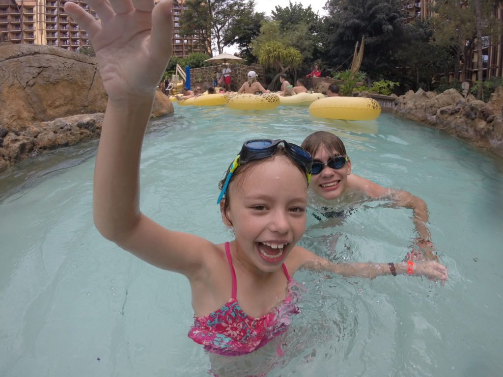 a girl and boy in a pool