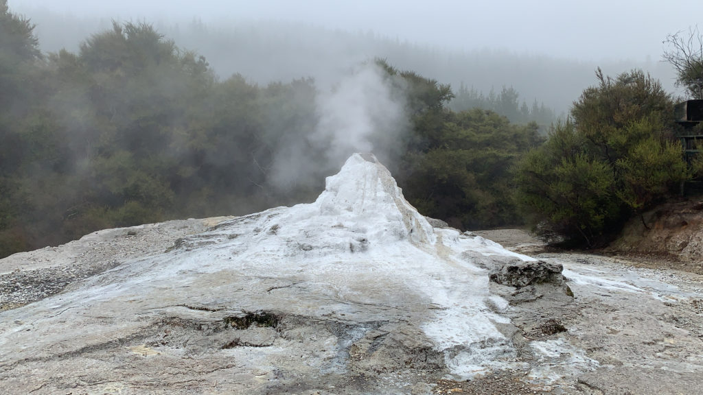 a white steam coming out of a mountain