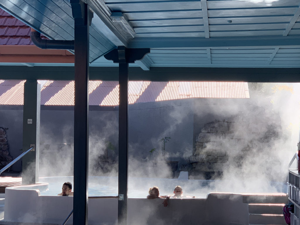 people in a hot tub with steam coming out of it
