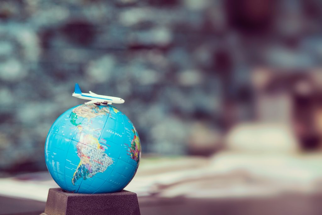 a model airplane on top of a globe