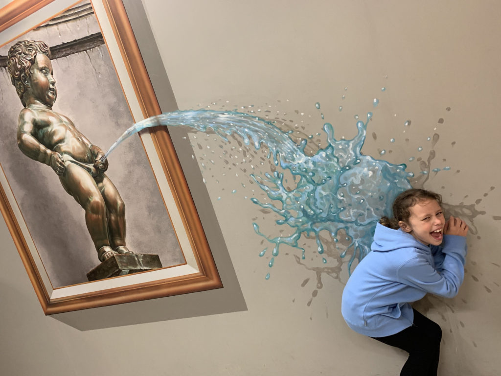 a girl playing with water on the wall