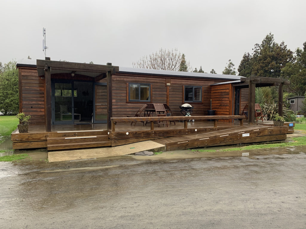 a wooden house with a deck and a patio